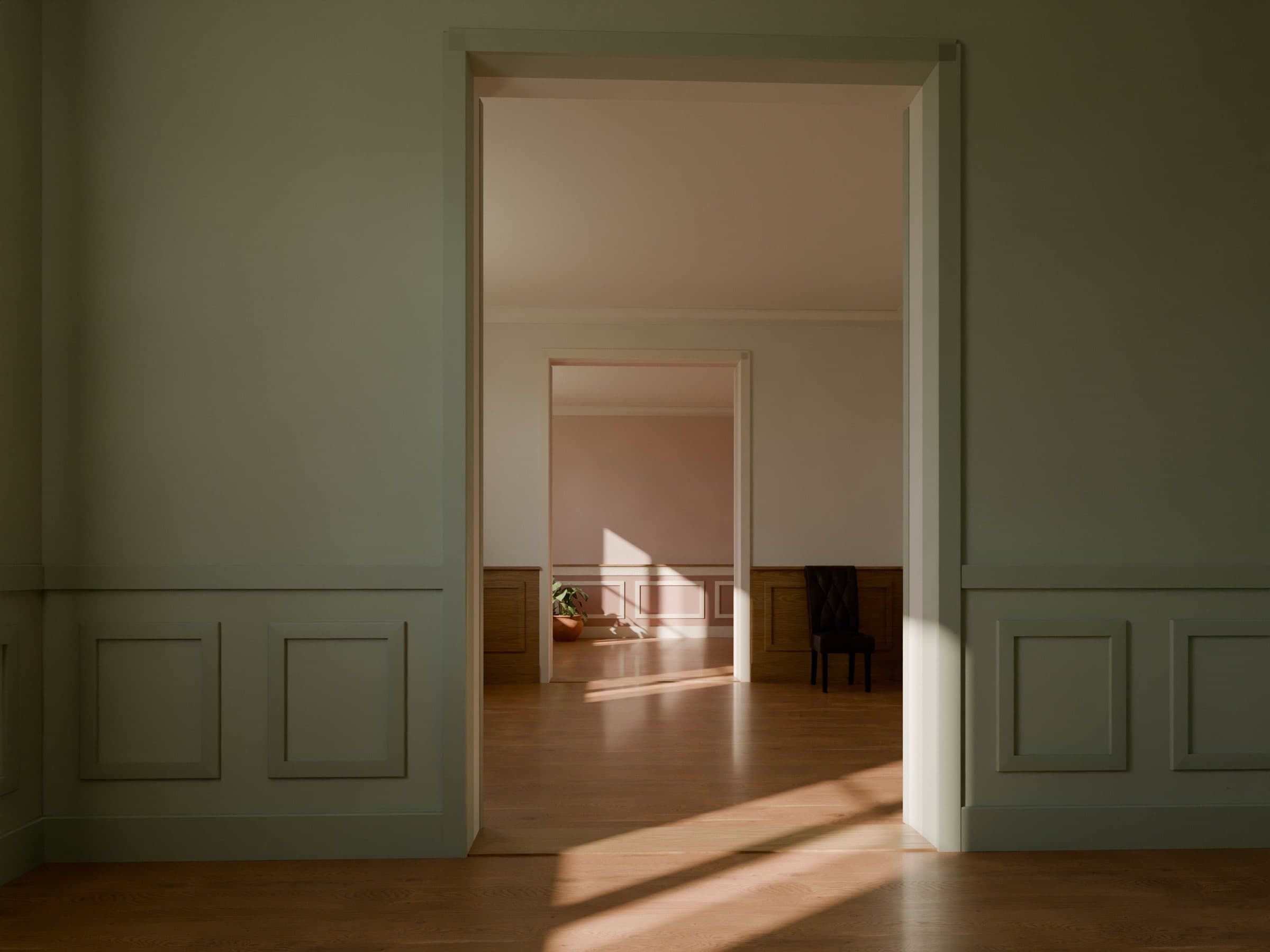 Setting: three rooms in enfilade, each with its dado panelling (moulded panels painted pale green, oak, then light panels on a pink wall)